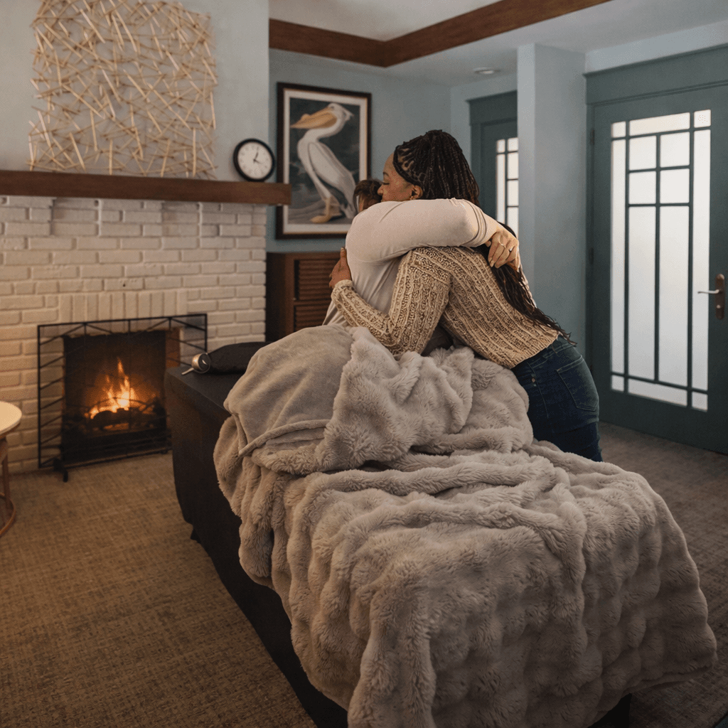 Hannah hugging a client after a session